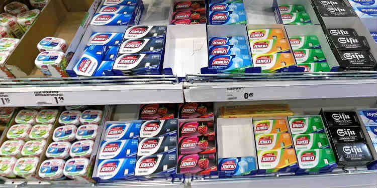 Packets of different types of chewing gum on a store shelf