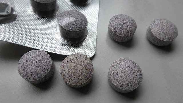 Speckled medication tablets inside and outside of a packet