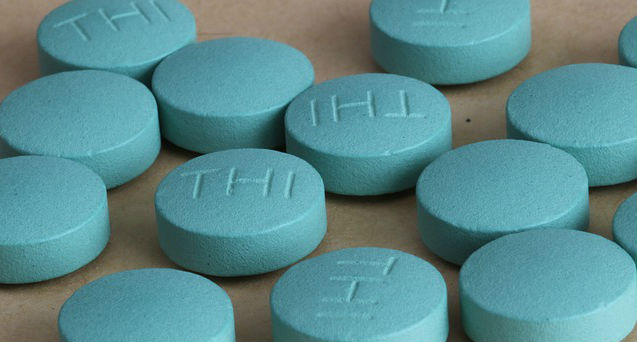 Blue medication tablets on a flat surface