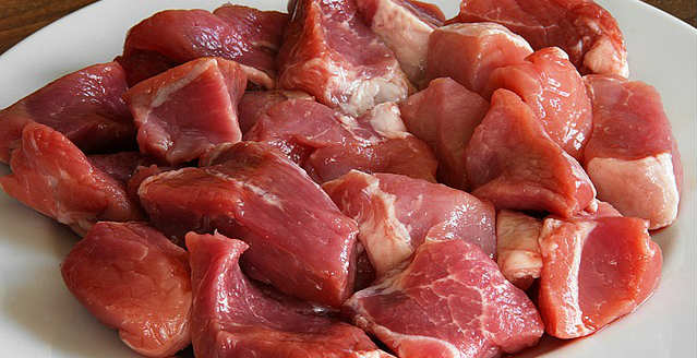 A plate of raw cubed pork