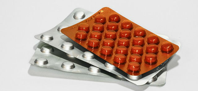 A stack of packets of medication tablets