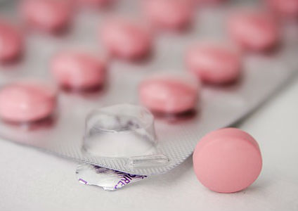 A packet of pink medication tablets