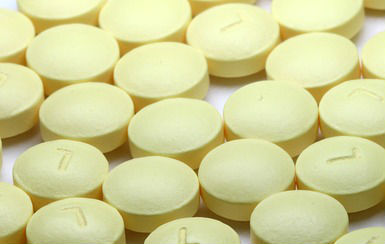 Yellow medication pills laying flat