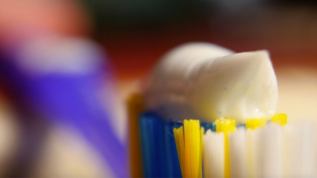 White toothpaste on a toothbrush head