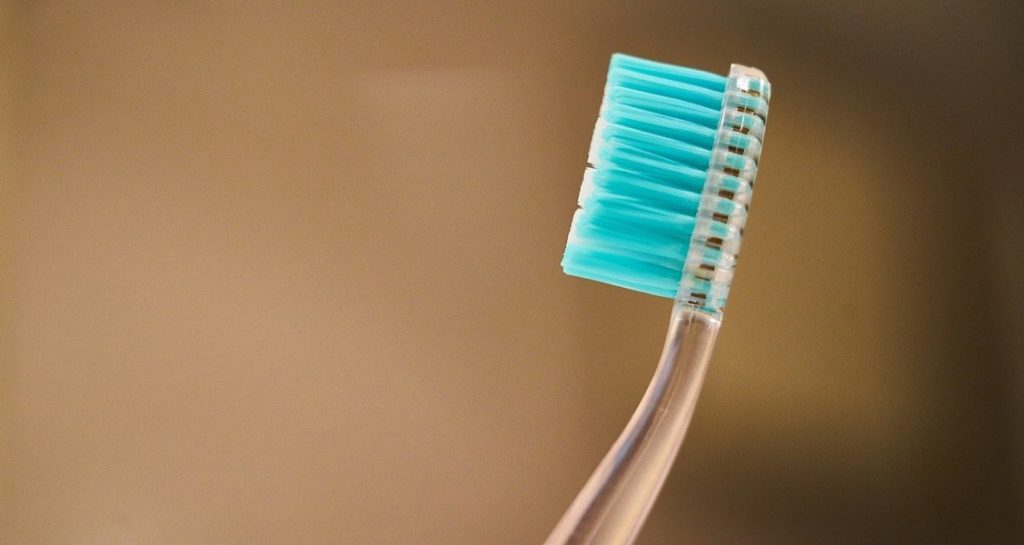 A clear toothbrush with light blue bristles