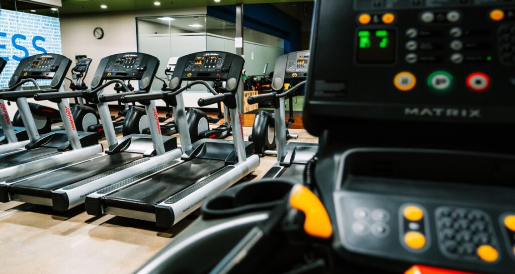 A row of treadmills inside a gym