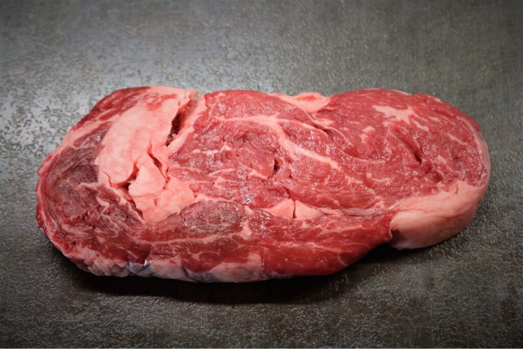 A raw rib eye beef steak