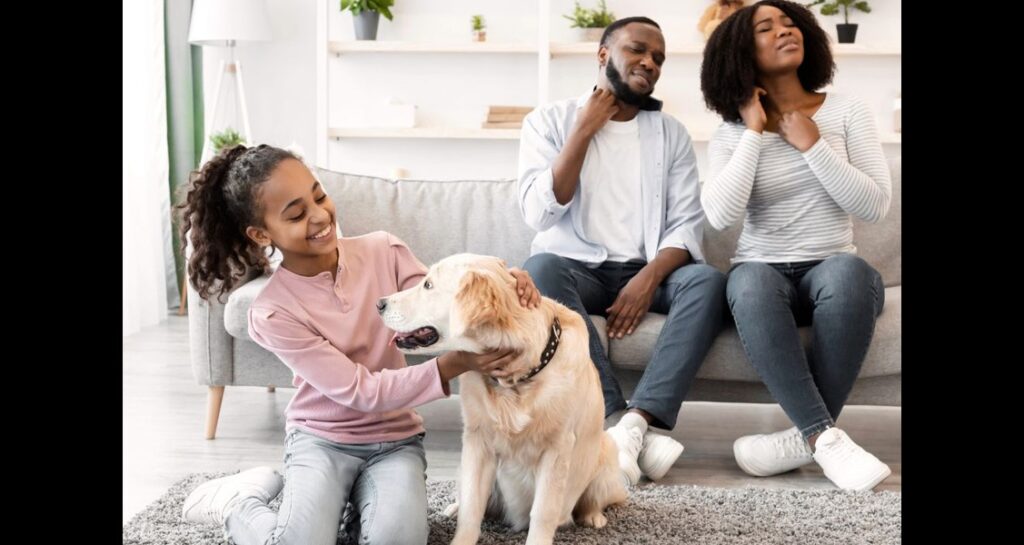 Parents are scratching their neck while a child is touching a dog